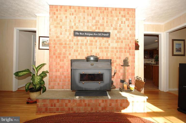7037 Long View Road Columbia, MD 21044 - Photo 7 of 24 Brick FP with wood-burning hearth stove