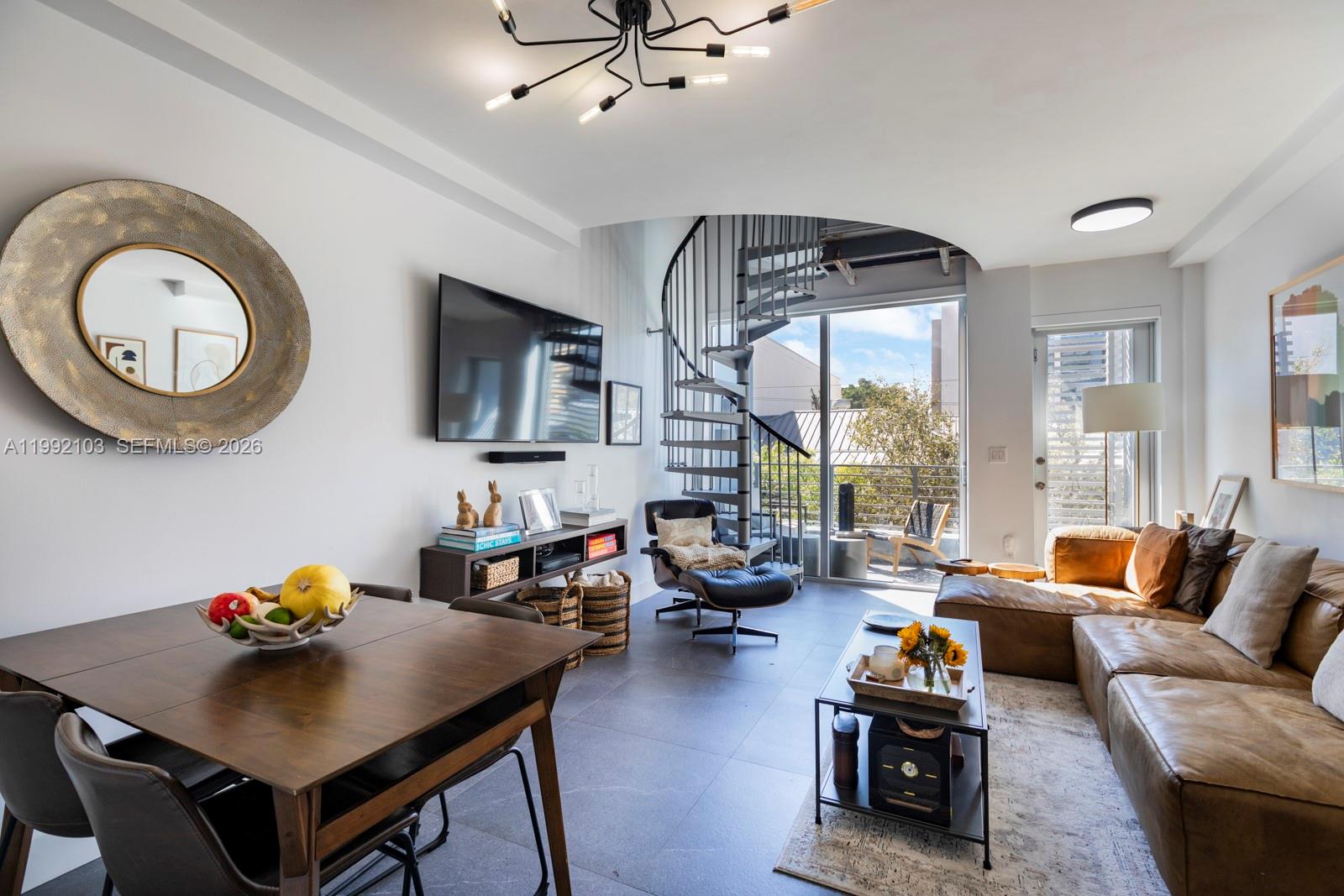 a living room with furniture a flat screen tv and a large window