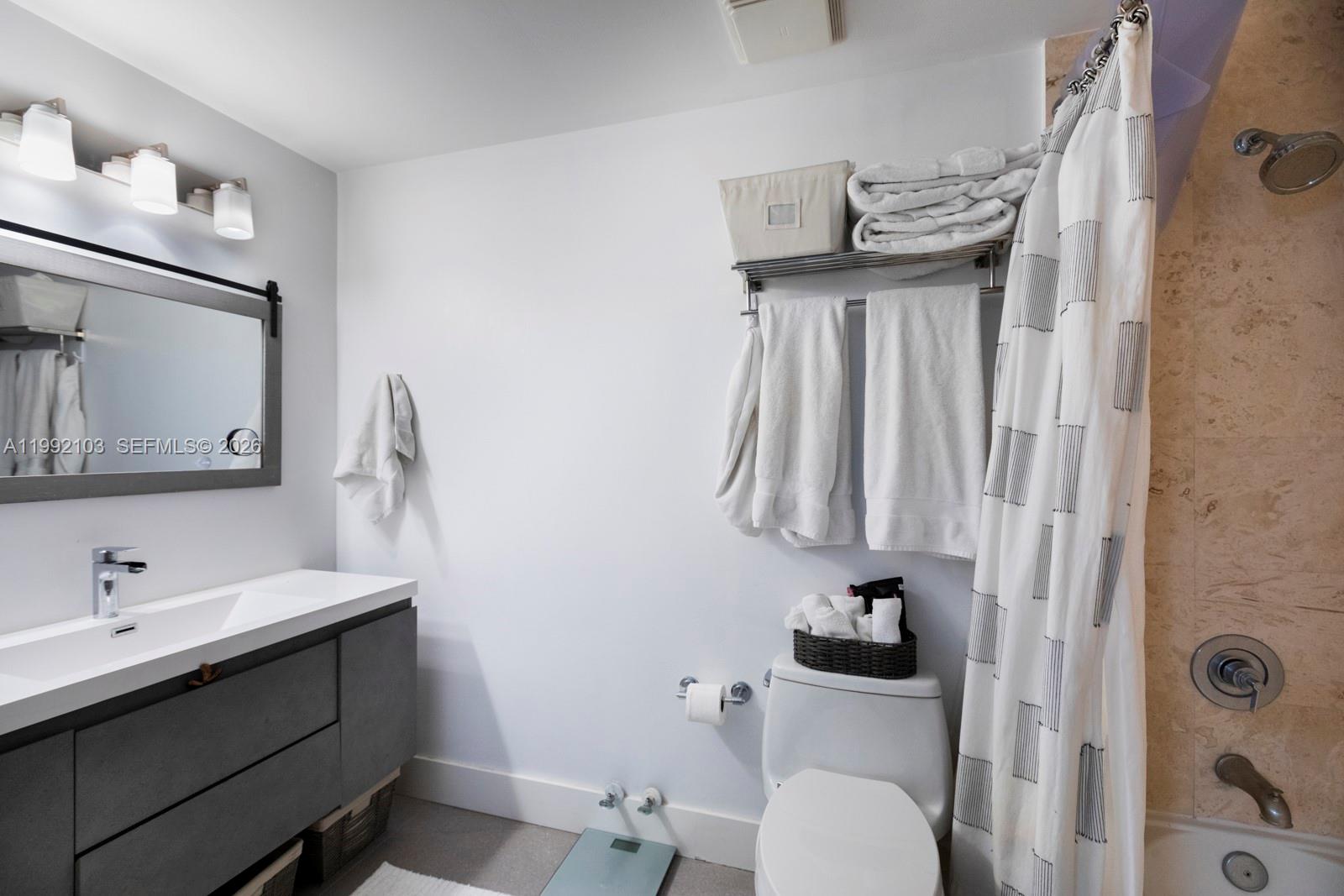 3339 Virginia Street, Unit 311 Miami, FL 33133 - Photo 15 of 16 a bathroom with a sink vanity mirror and toilet