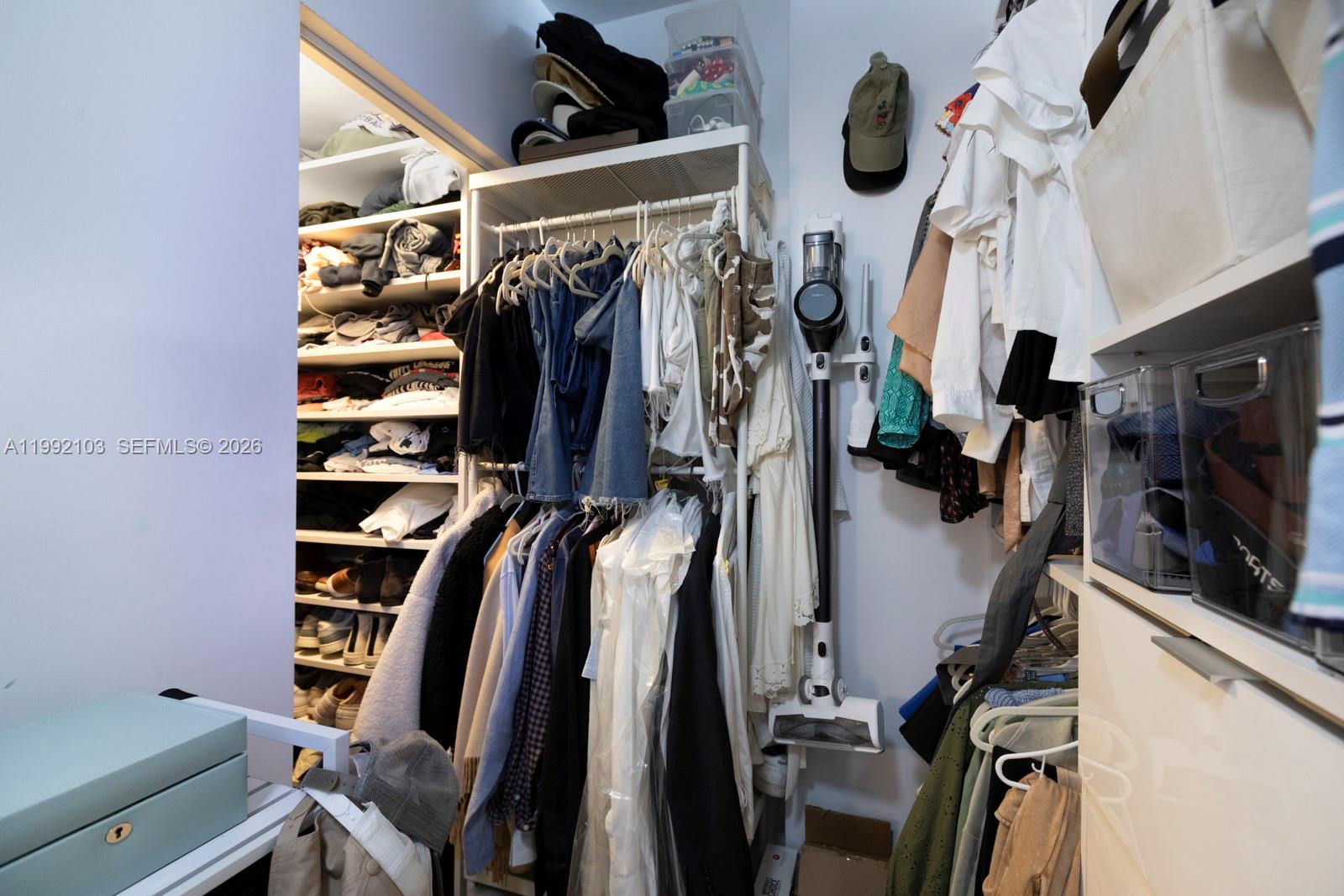 3339 Virginia Street, Unit 311 Miami, FL 33133 - Photo 16 of 16 a view of walk in closet with clothes and shoes