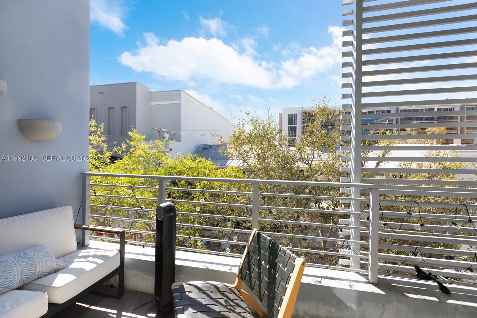 3339 Virginia Street, Unit 311 Miami, FL 33133 - Photo 7 of 16 a view of a balcony with wooden floor