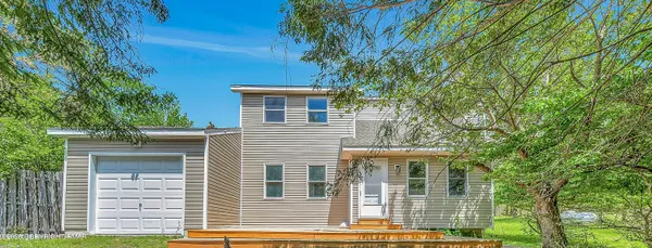 a view of a house with a tree