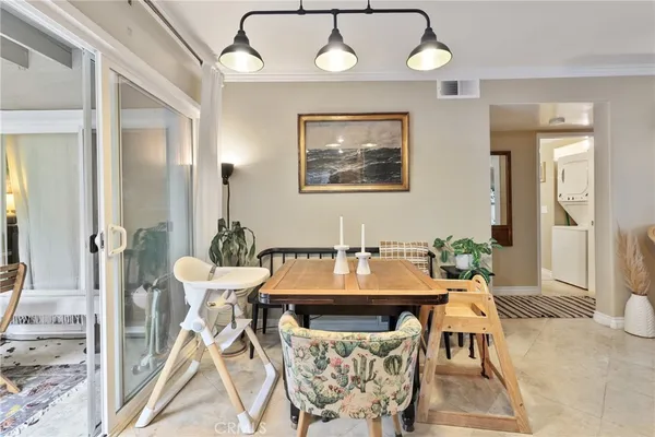 a view of a dining room with furniture and a chandelier