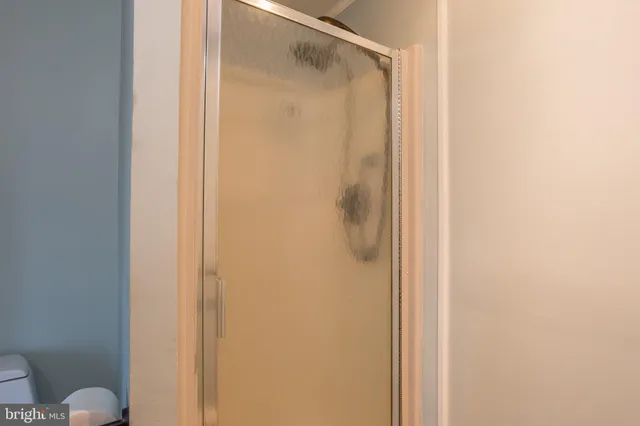 a bathroom with a glass shower door