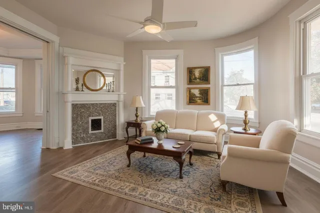a living room with furniture a window and a fireplace