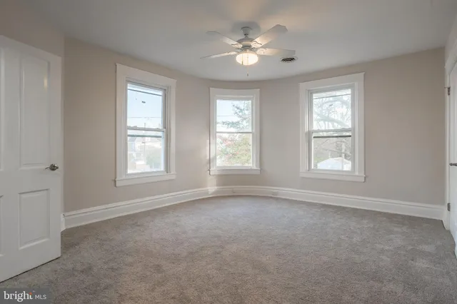 a bedroom with a bed couches and dresser