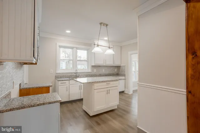 a kitchen with granite countertop cabinets stainless steel appliances and a sink