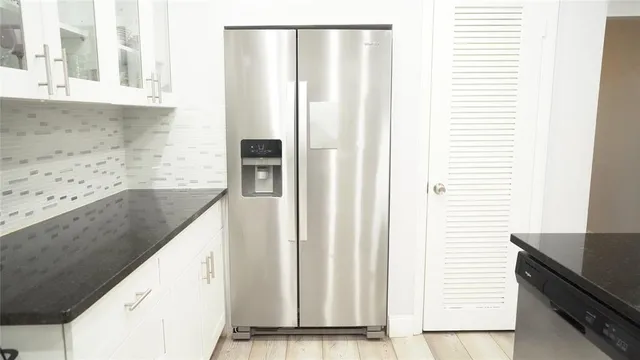 a view of a kitchen from a hallway