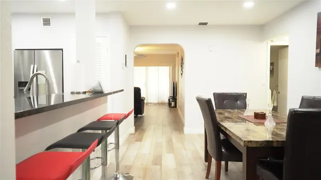 a dining room with furniture and wooden floor