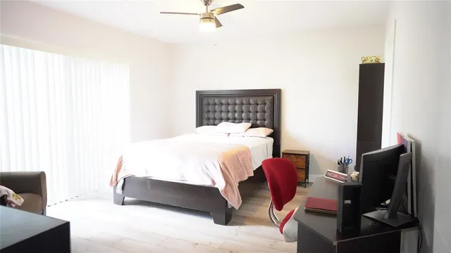 a bedroom with a bed and chair