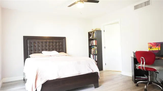 a bed room with a bed and a chair