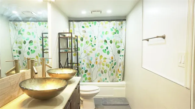 a bathroom with a toilet a sink and a shower