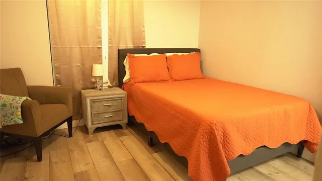 a bedroom with a bed and a chair