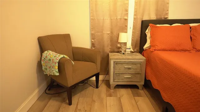 a bedroom with a bed and a chair