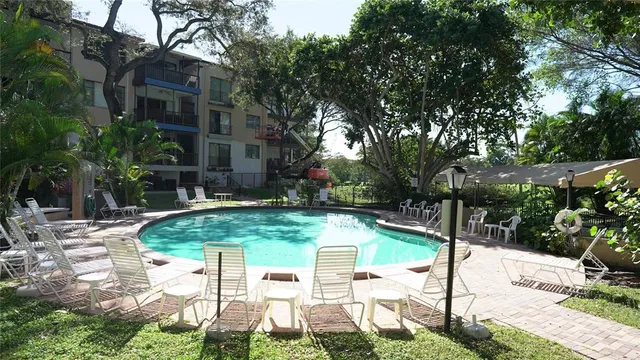 a view of backyard with swimming pool and outdoor seating