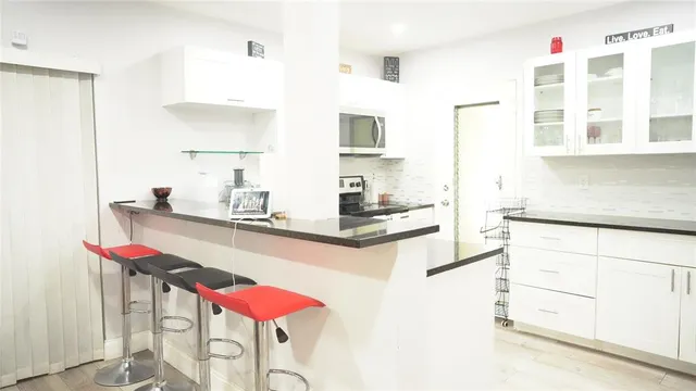 a kitchen with a sink and cabinets