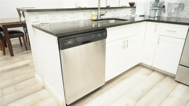 a kitchen with a sink and a refrigerator