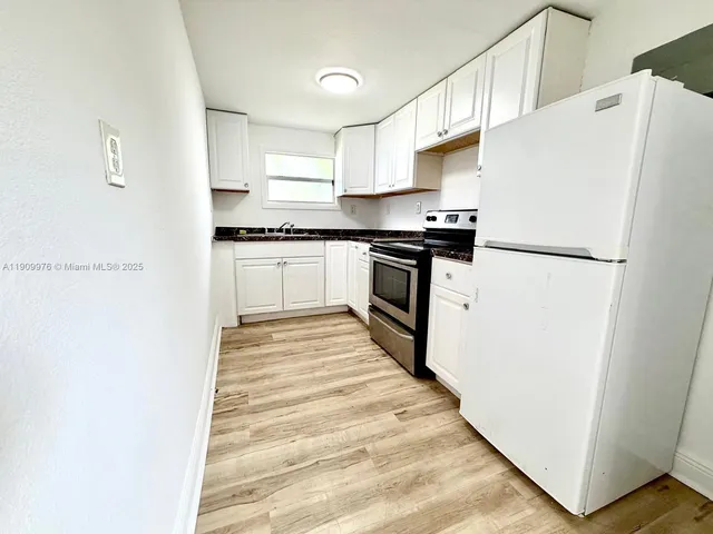 a white refrigerator freezer sitting inside of a kitchen