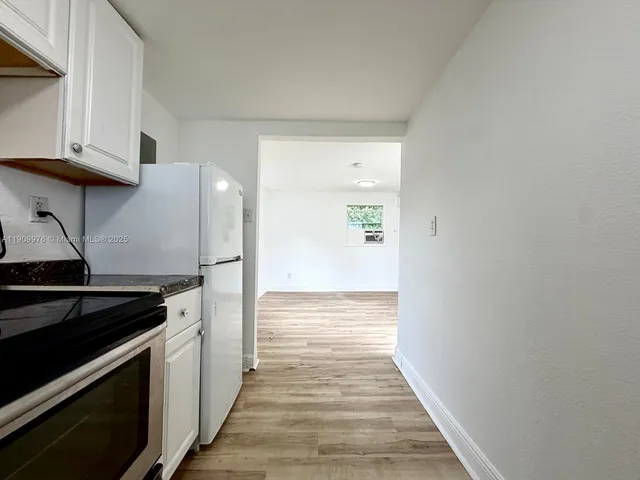 a kitchen with wooden floor and a stove