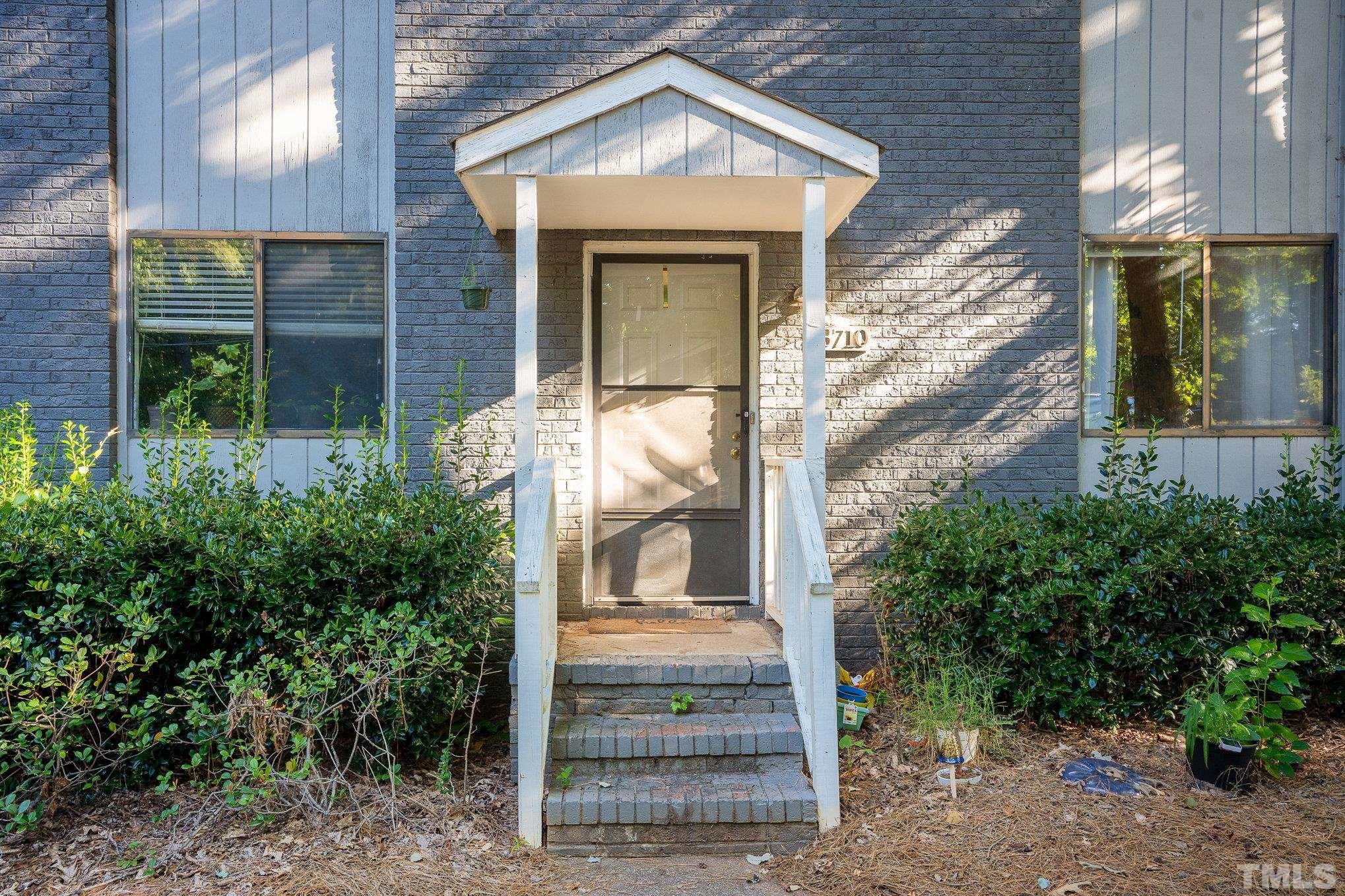 3710 Greenleaf Street Raleigh, NC 27606 - Photo 4 of 12 a front view of a house with a yard