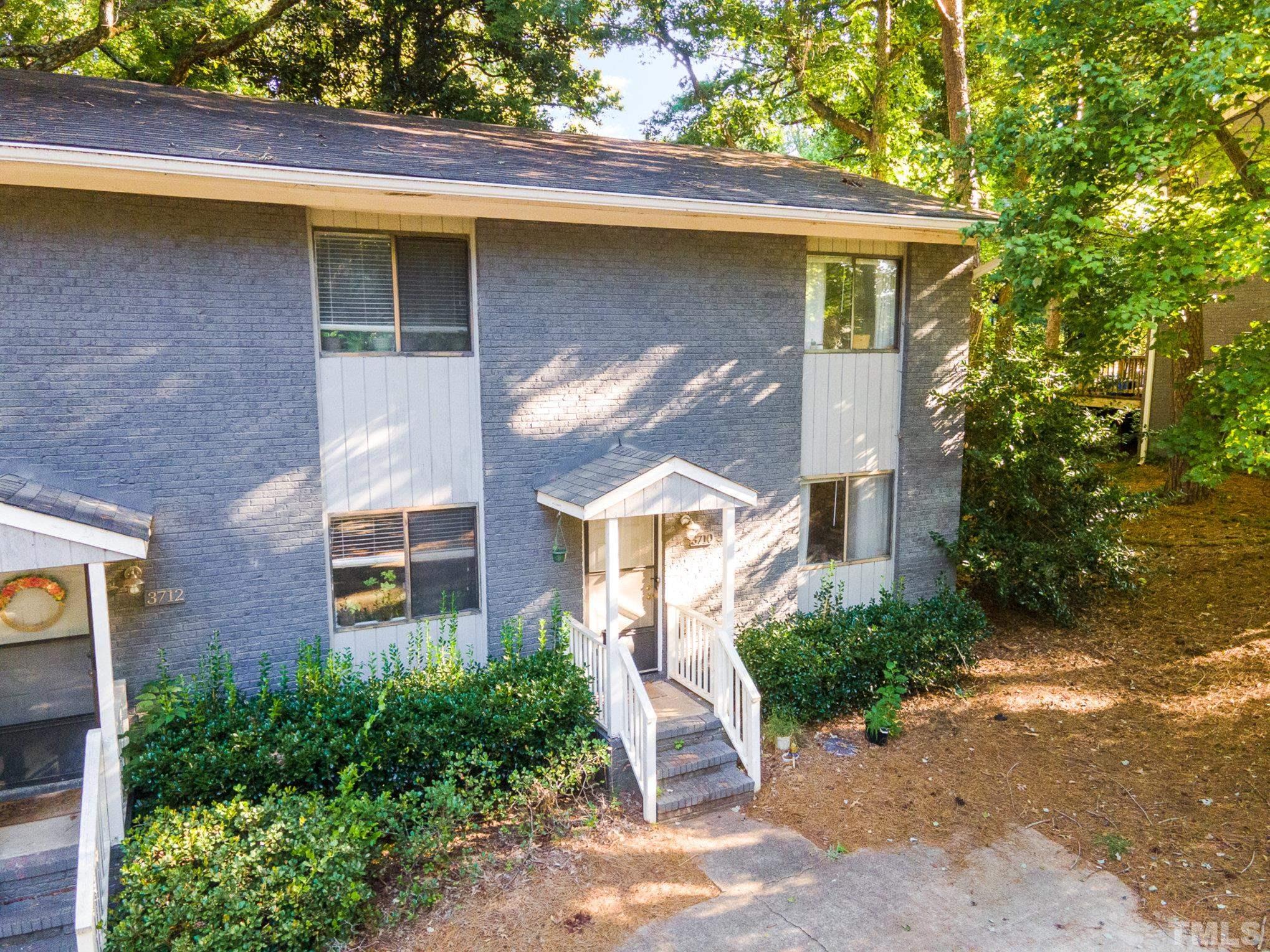 3710 Greenleaf Street Raleigh, NC 27606 - Photo 8 of 12 a view of a wooden house with a yard