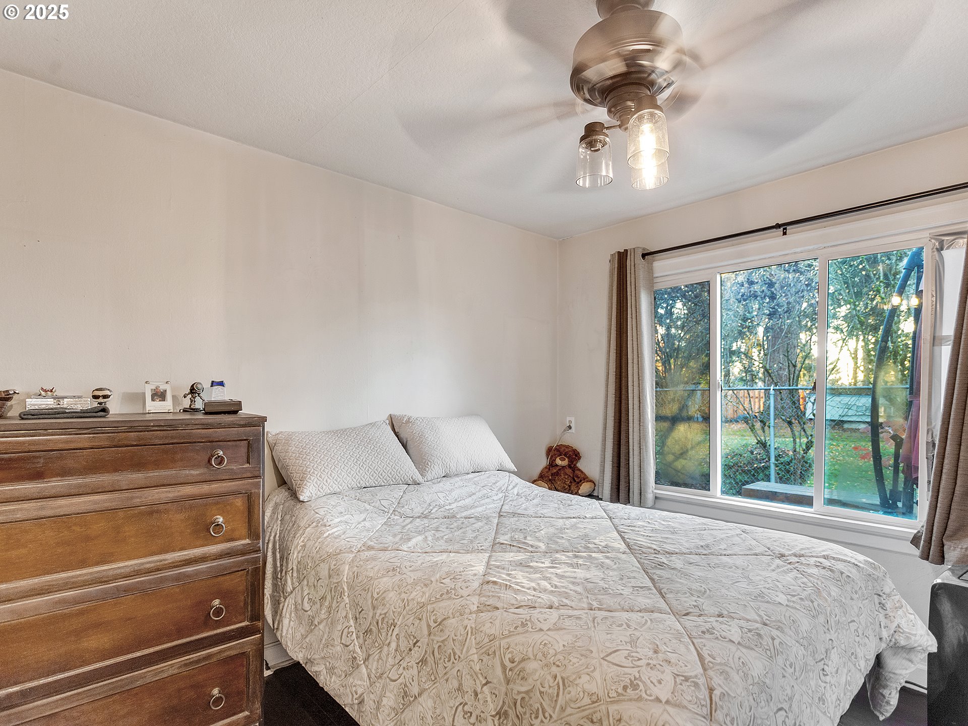 299 Southwest 3rd Avenue Canby, OR 97013 - Photo 11 of 32 a bedroom with a large bed and a chandelier