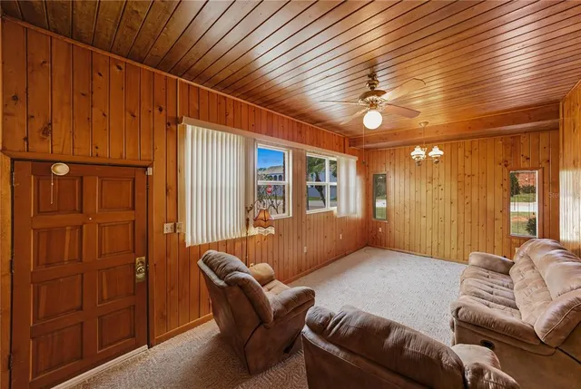 a living room with furniture ceiling fan and a window