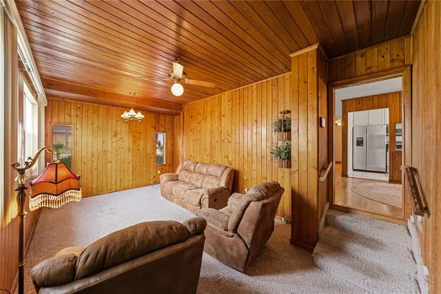 a living room with furniture a ceiling fan and a rug