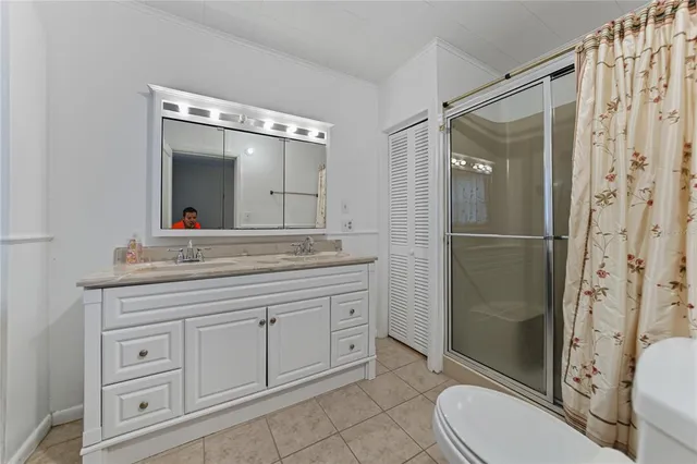 a bathroom with a granite countertop sink toilet mirror and shower