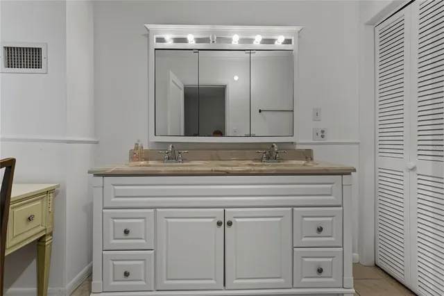 a spacious bathroom with a sink and a mirror