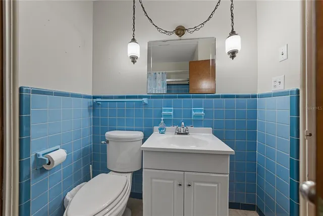a bathroom with a toilet a sink and shower