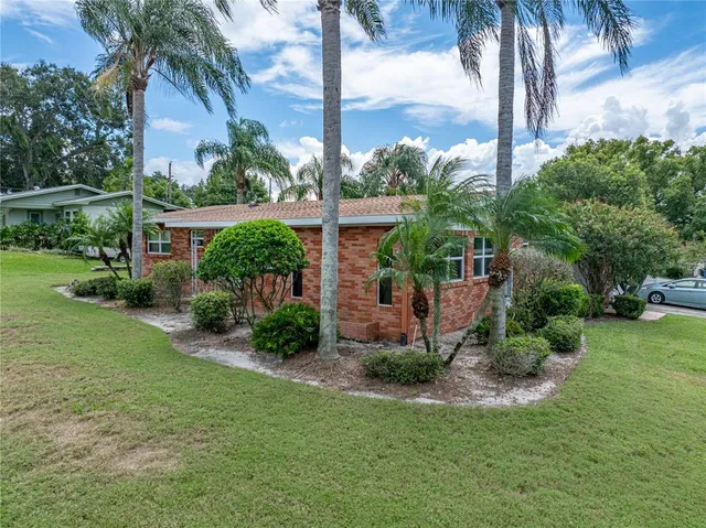 a view of a house with a yard and sitting area