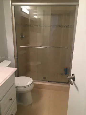 a bathroom with a toilet and a shower