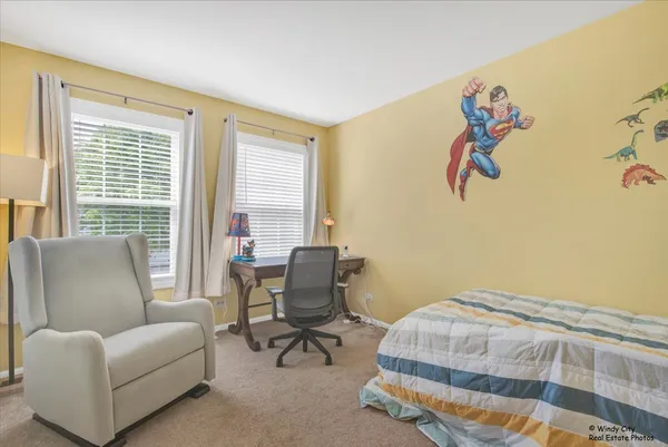 a bedroom with furniture and a window
