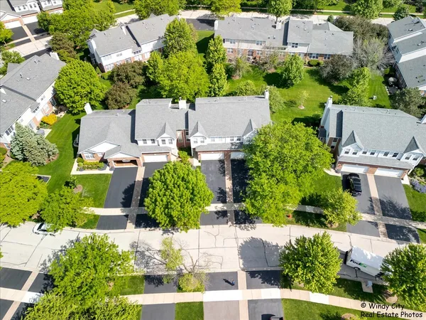 an aerial view of a house with a yard and lake view