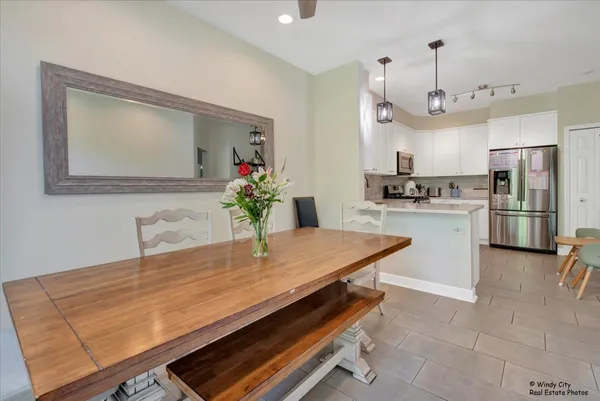 a dining room with kitchen island furniture a chandelier and kitchen view