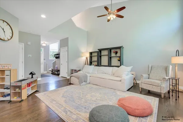 a living room with furniture a rug and a chandelier