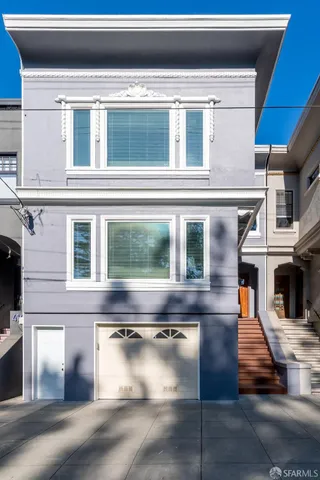 a kitchen with kitchen island granite countertop wooden floors stainless steel appliances and white cabinets