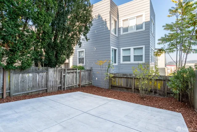 a large kitchen with stainless steel appliances kitchen island a large counter top a sink a stove and a refrigerator