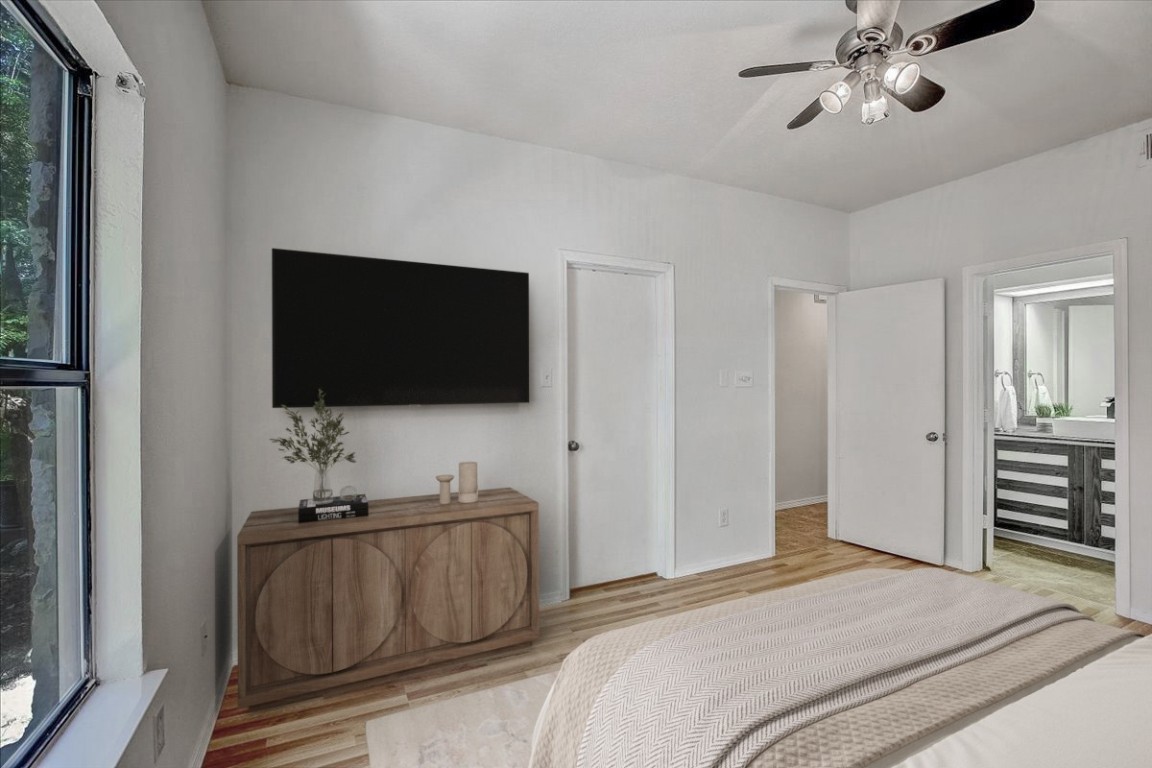 4711 Spicewood Springs Road, Unit 2112 Austin, TX 78759 - Photo 16 of 29 a bedroom with a bed and a flat screen tv
