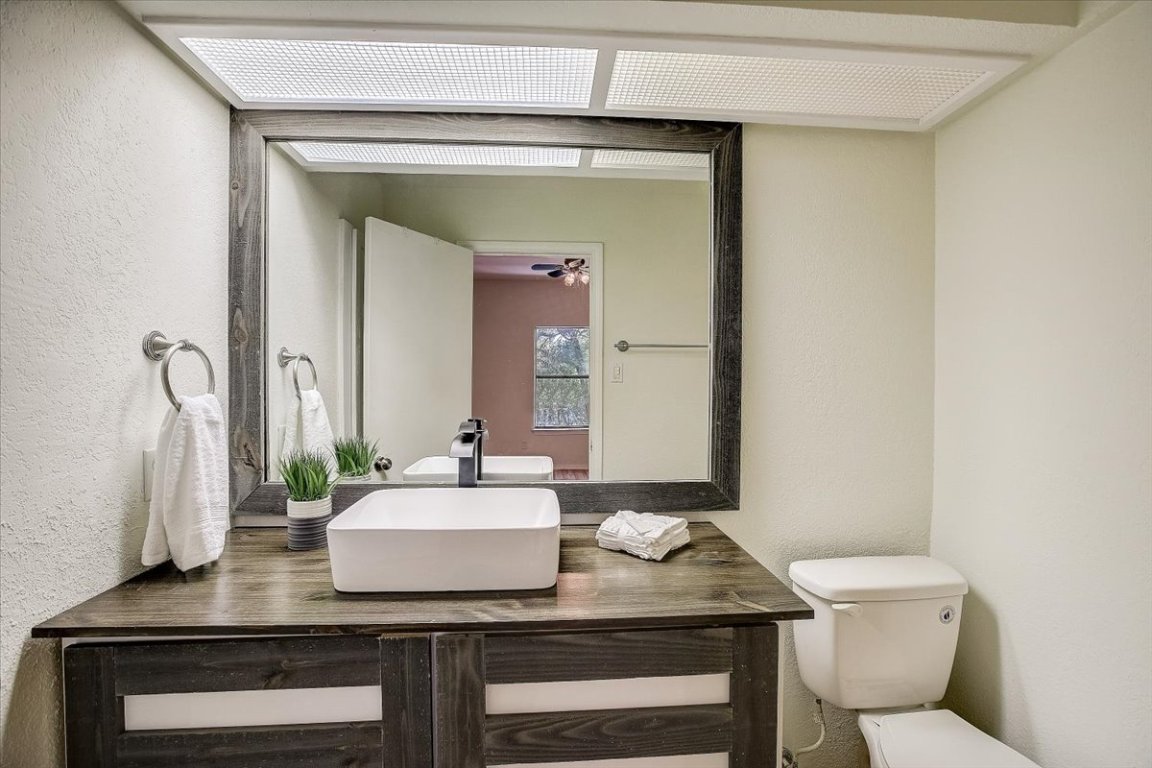 4711 Spicewood Springs Road, Unit 2112 Austin, TX 78759 - Photo 18 of 29 a bathroom with a granite countertop sink and a mirror