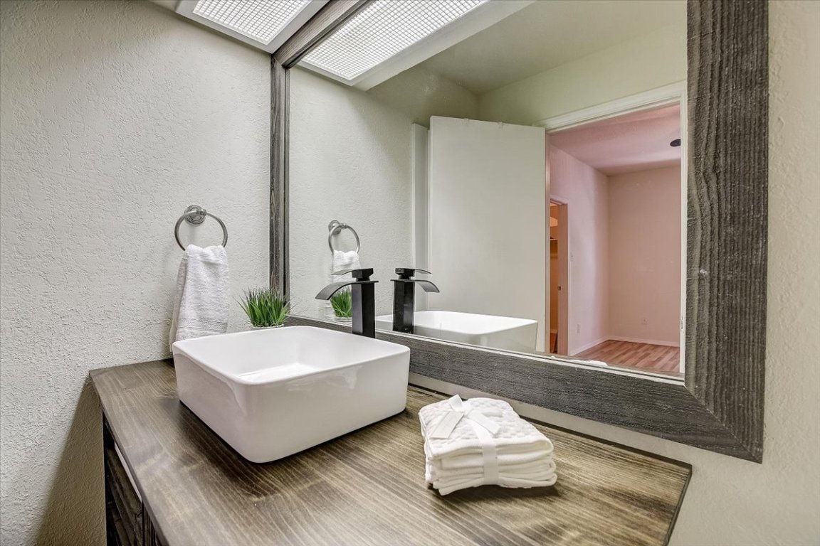 4711 Spicewood Springs Road, Unit 2112 Austin, TX 78759 - Photo 19 of 29 a living room with furniture and a wooden floor