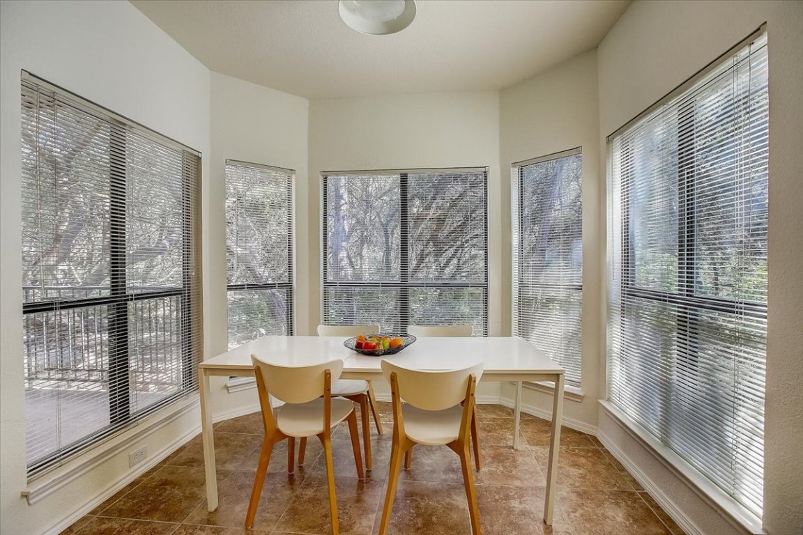 4711 Spicewood Springs Road, Unit 2112 Austin, TX 78759 - Photo 6 of 29 a dining room with furniture a chandelier and wooden floor