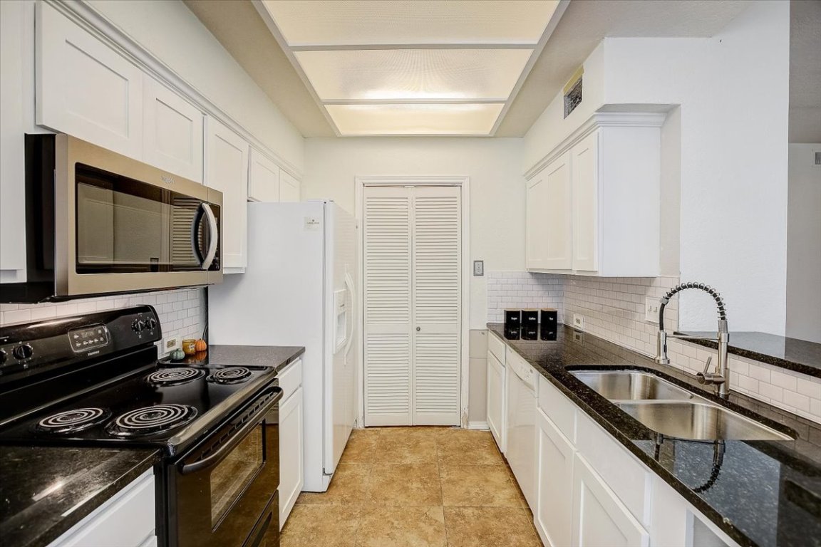 4711 Spicewood Springs Road, Unit 2112 Austin, TX 78759 - Photo 7 of 29 a kitchen with a sink stainless steel appliances and cabinets