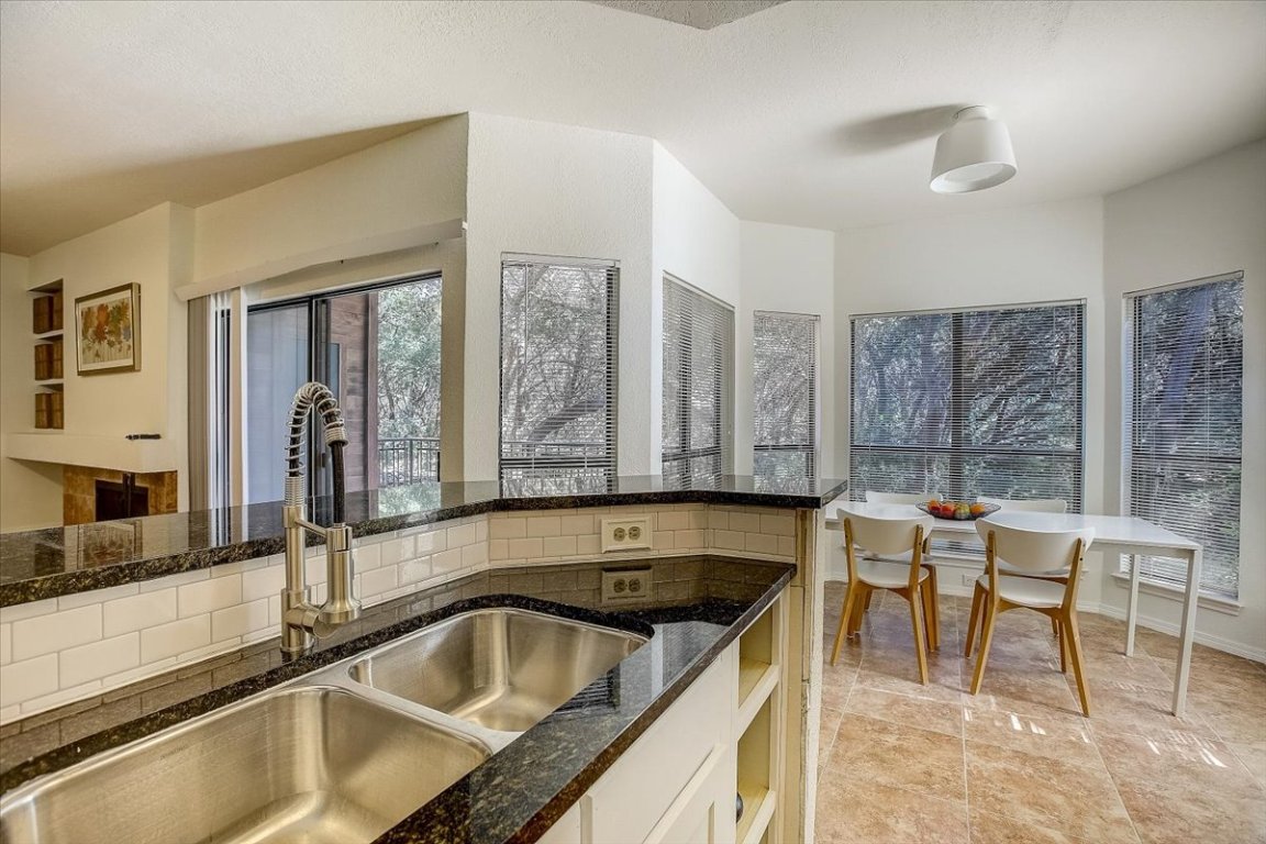 4711 Spicewood Springs Road, Unit 2112 Austin, TX 78759 - Photo 9 of 29 a kitchen with a sink and a stove top oven