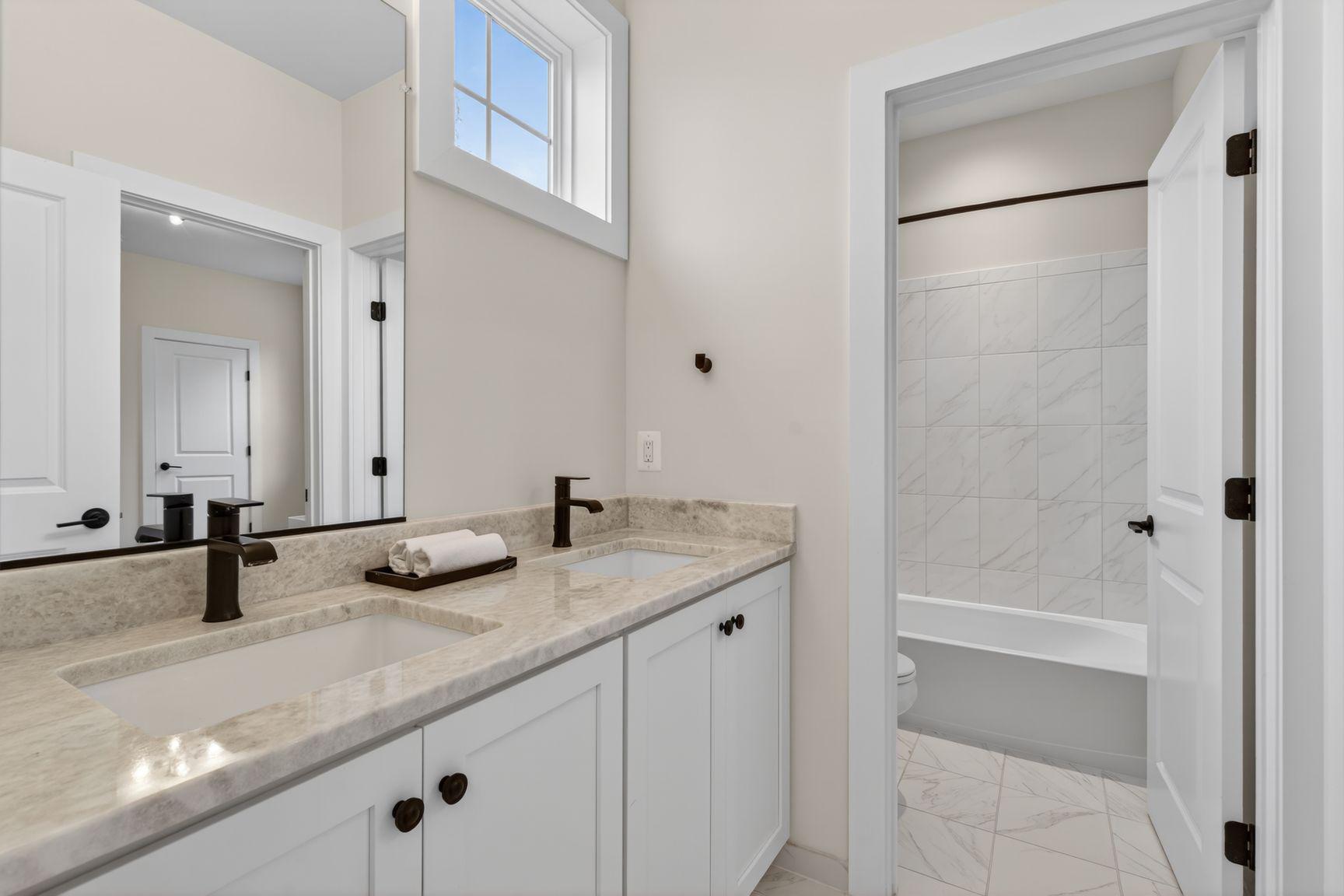 6213 Mcconnell Lane Springfield, VA 22152 - Photo 28 of 39 a bathroom with a granite countertop sink and a mirror
