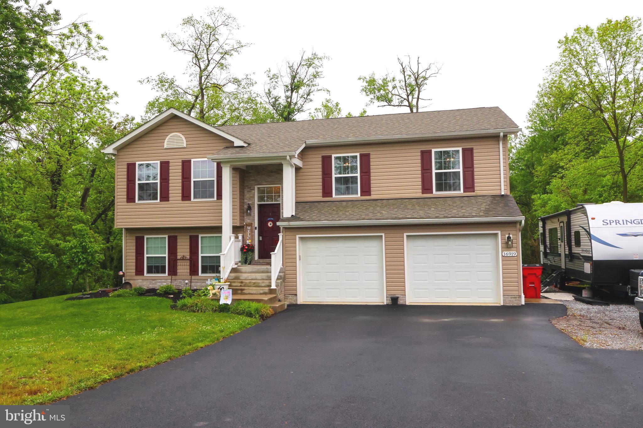 16919 Shaffer Road Sharpsburg, MD 21782 - Photo 2 of 58 a front view of a house with a yard and garage