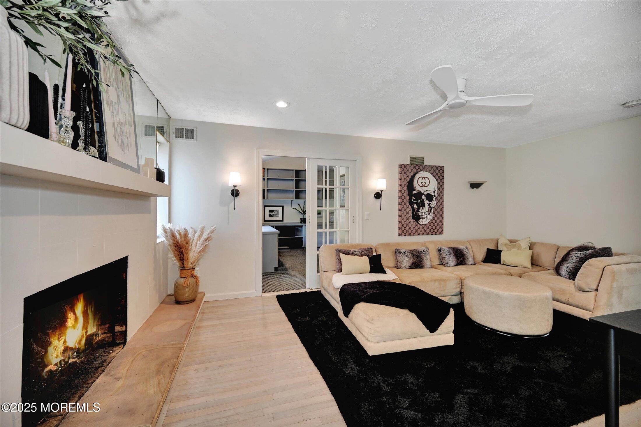 3 Woods Road West Long Branch, NJ 07764 - Photo 11 of 46 a living room with furniture and a fireplace