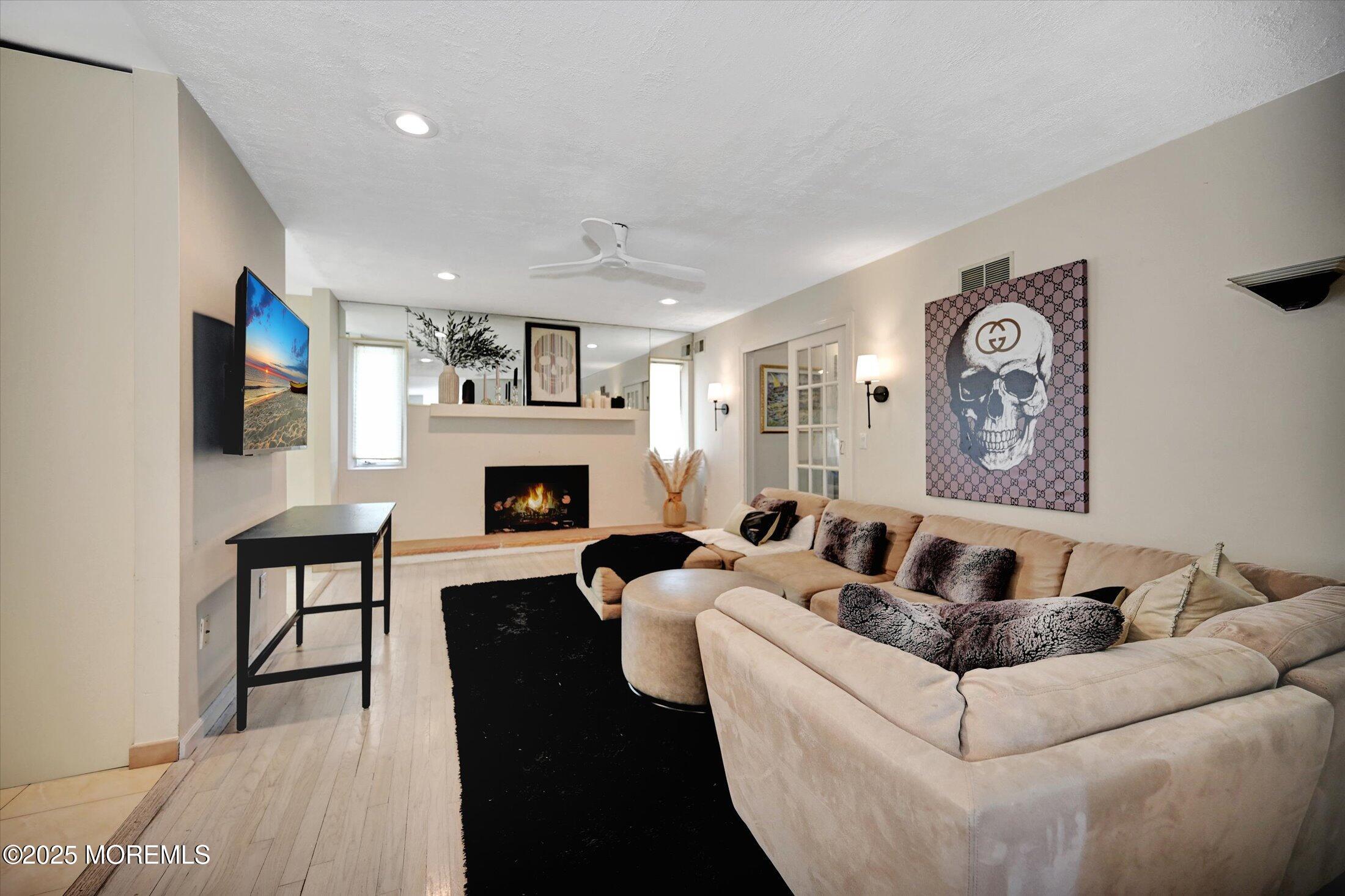 3 Woods Road West Long Branch, NJ 07764 - Photo 12 of 46 a living room with furniture and a fireplace