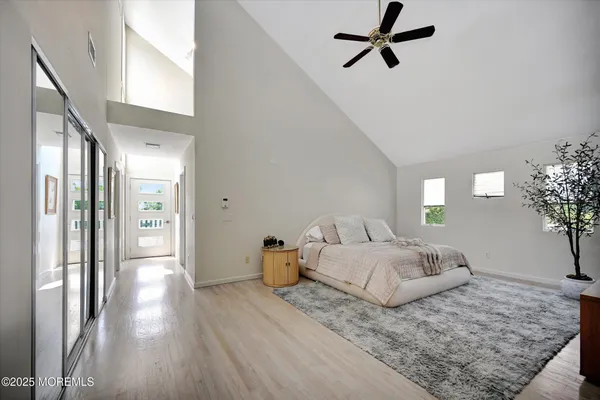 a bedroom with a bed and a chandelier